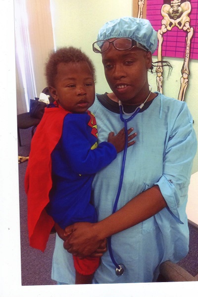 Baby dressed as superman and Mom dressed as a nurse at Make it Take it
